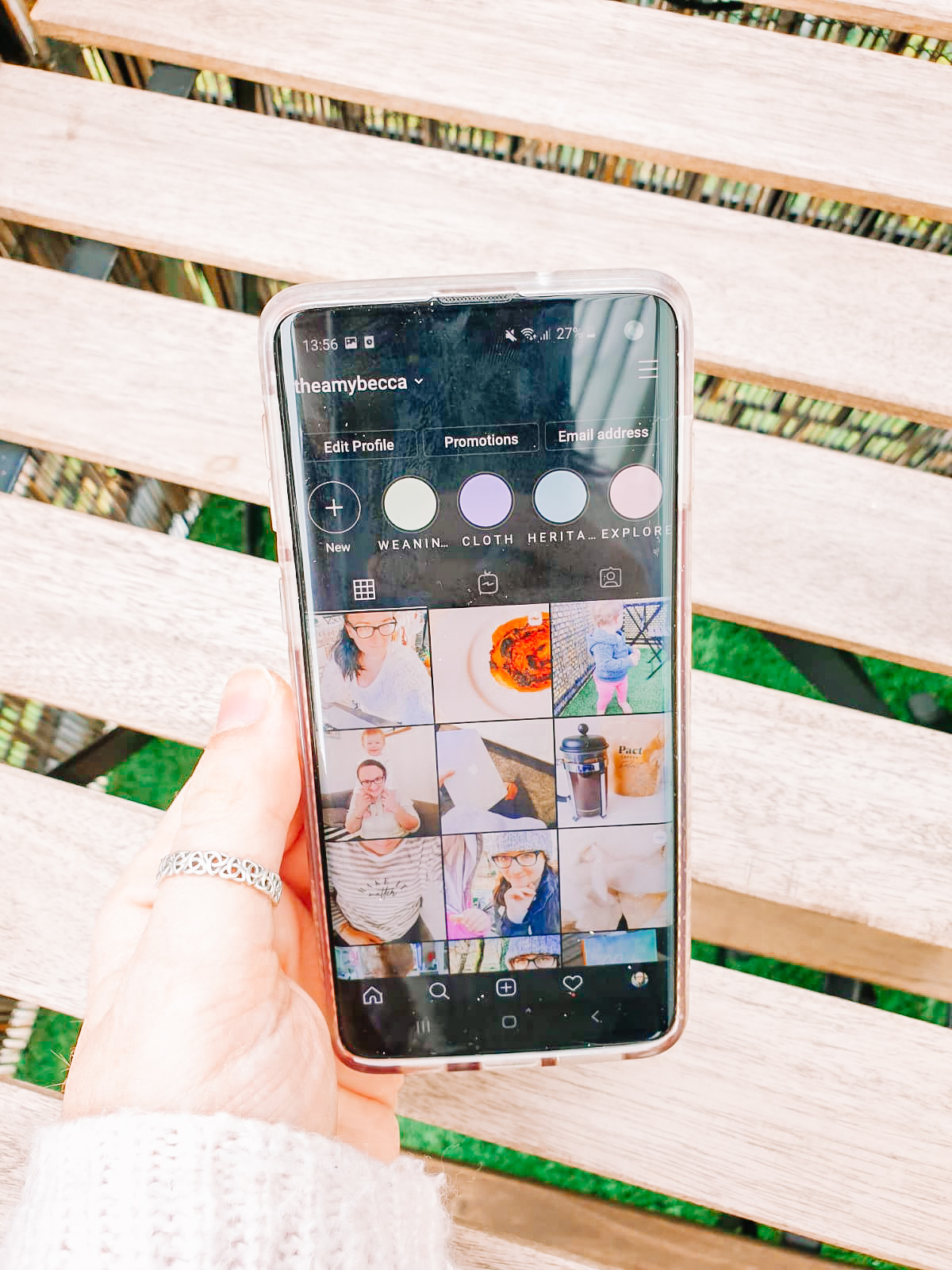 handing holding phone with photo of instagram grid